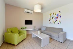 a living room with a couch and a table at Makronisos Village in Ayia Napa