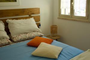 a bed with two pillows on it in a room at Casa Arcobaleno in Marsala