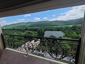 a balcony with a view of the mountains at Family Villa with Pool in Əski İqrığ