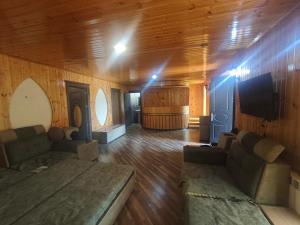 a living room with a couch and a television and a barrel at Family Villa with Pool in Əski İqrığ