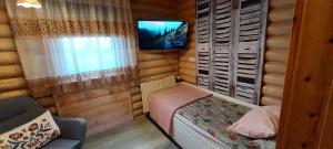 a small bedroom with a small bed and a tv at Solar eclipse Iceland Small studio in Kjalarnes in Reykjavík
