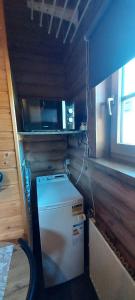 a small kitchen with a microwave and a small refrigerator at Solar eclipse Iceland Small studio in Kjalarnes in Reykjavík