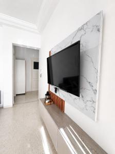 a flat screen tv hanging on a wall in a living room at Superb apartment Monastir in Monastir