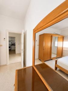 a bedroom with a bed and a mirror at Superb apartment Monastir in Monastir