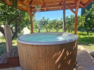 a large hot tub under a wooden gazebo at Villa La Cucullera in Catanzaro