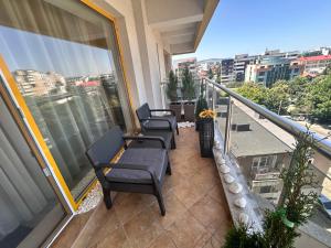 a balcony with chairs and tables on a building at Silver De Lux in Bacău