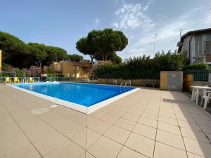 a swimming pool in a yard next to a house at Vear Hausing - Volano 80 int 8 in Lido di Volano