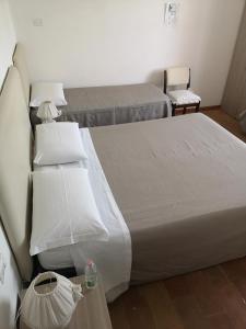 a bedroom with two beds with white pillows at Il Gelsomino in Foligno