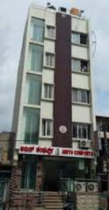 a tall building with a sign in front of it at Amith Comforts near to Railway Station in Mysore