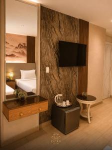 a hotel room with a bed and a television on a wall at Grand lotus hotel downtown in Cairo