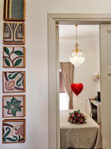 a room with a table with a heart on the wall at Kèramos Luxury Rooms in Sciacca +178 photos