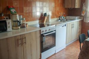 a kitchen with a white stove and a sink at Casa Fernando in Burela de Cabo
