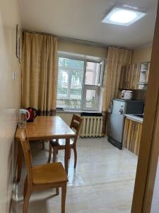 a kitchen and dining room with a table and chairs at Cozy 2 BR Apartment with Easy Access in Ulaanbaatar