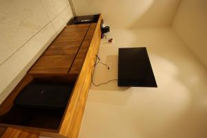 a room with a wooden counter with a black table at Meenar Hotel in Meerut
