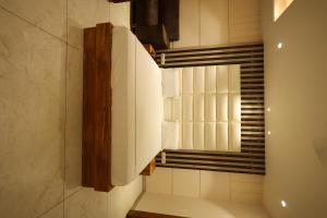 a bathroom with a mirror and a window at Meenar Hotel in Meerut +7 photos