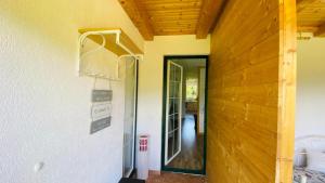 a door to a house with a sign on the wall at BergZeit in Warbach +22 photos