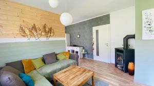 a living room with a couch and a wood stove at BergZeit in Warbach