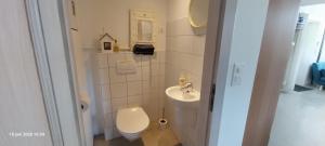a small bathroom with a toilet and a sink at Gîte La Cour Cachée in Saulx-en-Woëvre +23 photos