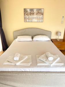 a bedroom with a bed with two towels on it at Balchik English House in Balchik