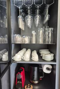 a cupboard filled with dishes and glass jars at Kabata 2620 ` Кабата 2620 in Bansko +60 photos