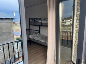 a door leading to a balcony with a bunk bed at aROYAL in Cholpon-Ata
