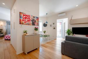 a living room with a couch and a table at Martini Matera 2-luxury apartment in Matera