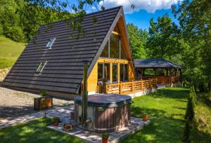 a tiny house with a gazebo at Cabana Ulici A-frame in Bîrsana
