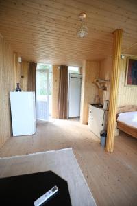 a room with a refrigerator and a bed in it at Akho Panorama in Batumi