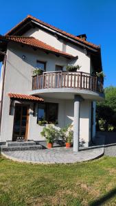 a house with a balcony on top of it at Casa Maria in Avrig +5 photos