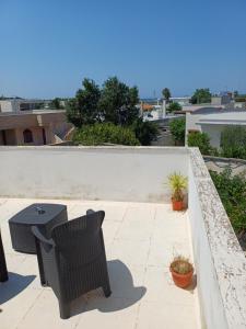 a patio with two chairs and a table on a roof at Villa Alma in Bari