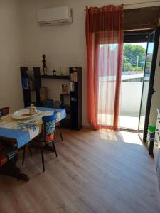 a living room with a table and chairs and a window at Villa Alma in Bari +65 photos