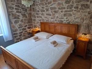 a bedroom with a bed with two towels on it at House Antica in Lastovo