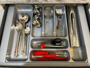 a metal sink with silver utensils in it at Beruru Homes- 2BHK Apartment near Bengaluru Airport in Devanhalli