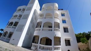 a white building with two towers at Hermit Homes in Mombasa