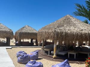 a group of straw huts on the beach at Triumph Fantastic View in Sveti Vlas