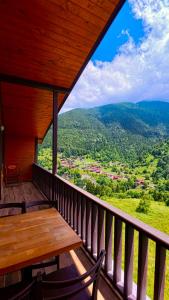 a balcony with a table and chairs and a view at Badul Pansiyon in Uzungöl