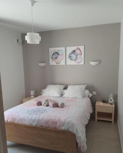 a bedroom with a bed with two babies laying on it at LA MASTRONA in Saumane-de-Vaucluse +26 photos
