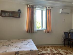 a bedroom with a bed and a window at Жилье на природе с бассейном in Tashkent +31 photos