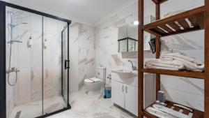 a bathroom with a shower and a sink and a toilet at JUNGLOW Sapanca in Sapanca +4 photos