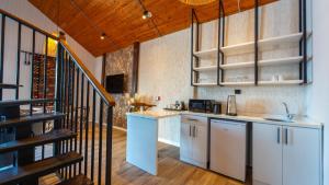 a kitchen with white cabinets and a staircase at JUNGLOW Sapanca in Sapanca
