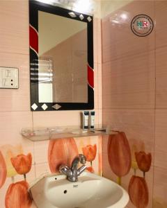 a bathroom with a sink and a mirror at Hotel Indrawoti and Resort in Dhulikhel +48 photos