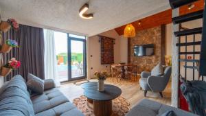 a living room with a couch and chairs and a table at JUNGLOW Sapanca in Sapanca