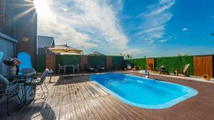 a patio with a swimming pool and a wooden deck at JUNGLOW Sapanca in Sapanca