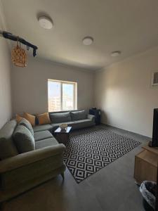 a living room with a couch and a rug at أوريانا oRIANA in Jeddah