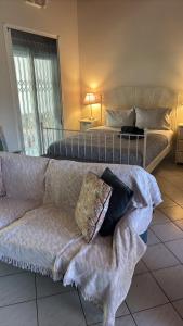 a living room with a bed and a couch at Little Summer Chalet in Saronida