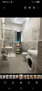 a bathroom with a washing machine and a sink at Casa Vacanze Alba in Pianillo +9 photos