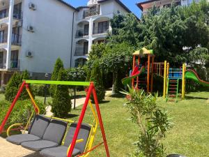 a playground in a yard next to a building at Triumph Fantastic View in Sveti Vlas