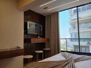 a bedroom with a bed and a large window at Montaza City in Alexandria