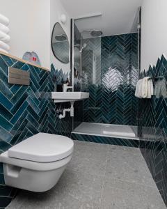 a bathroom with a toilet and a shower and a sink at Hôtel Restaurant la Couronne in Chamonix +43 photos