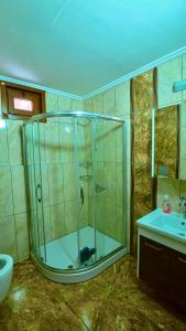 a bathroom with a glass shower and a sink at Badul Pansiyon in Uzungöl +29 photos